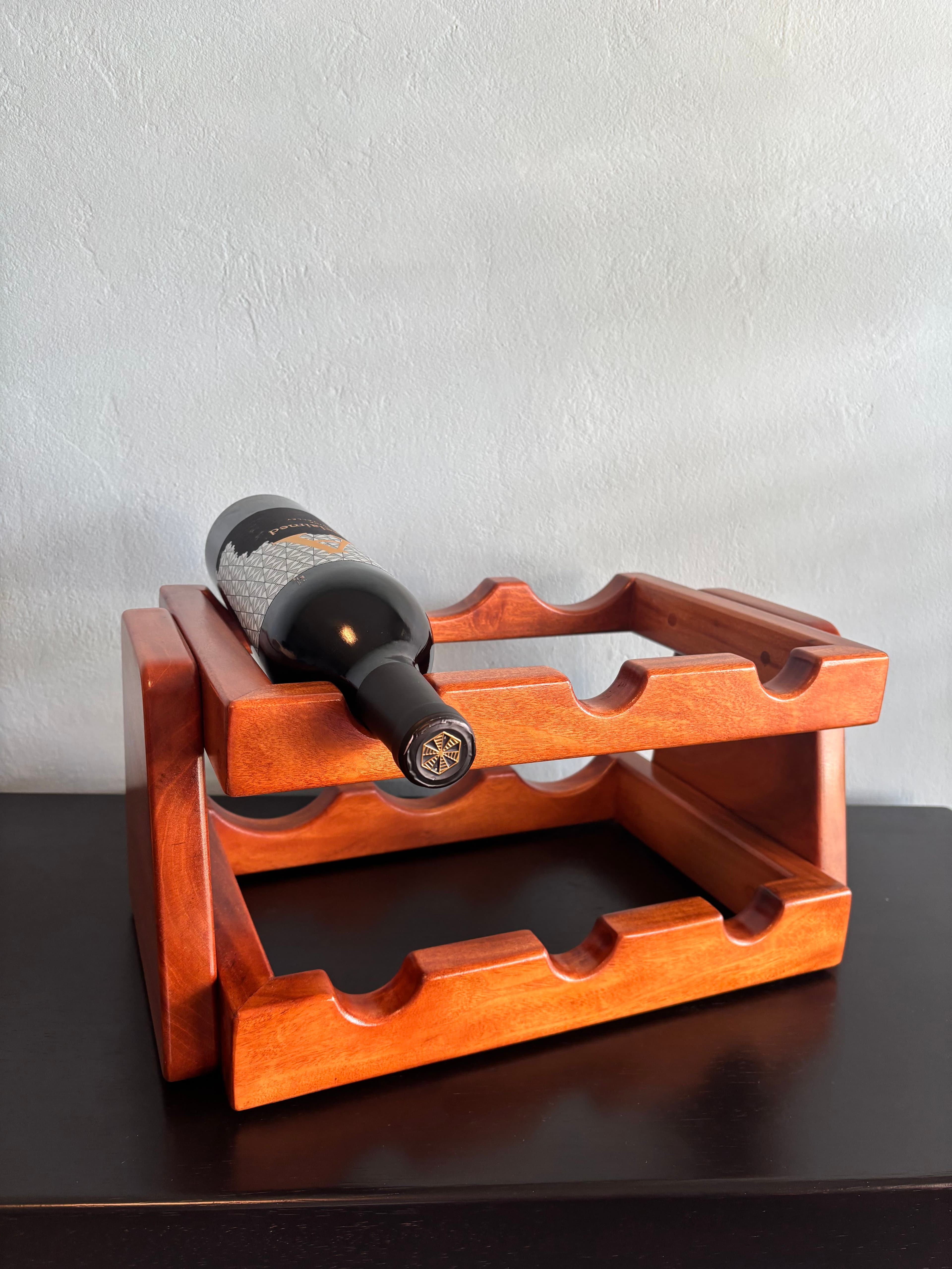 Mahogany wine rack holding a bottle of wine